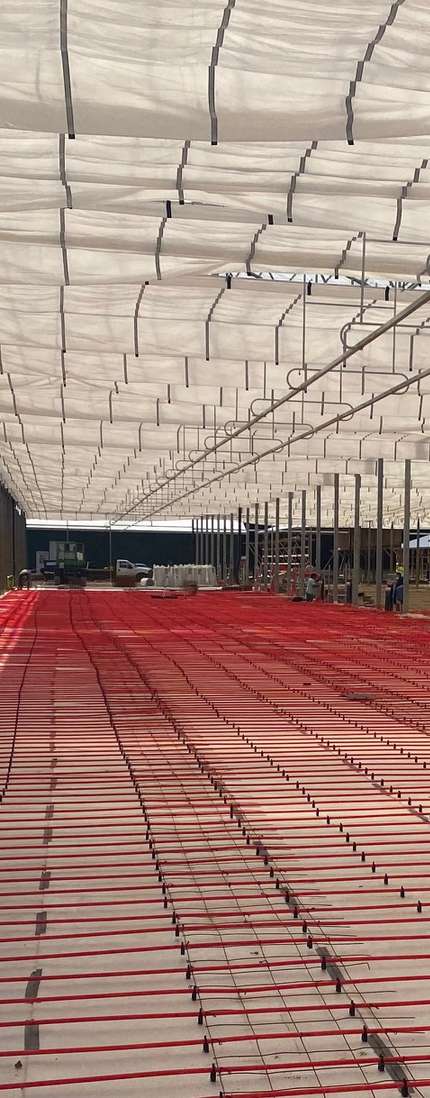 Radiant floor tubing installed across the greenhouse floor prior to pour